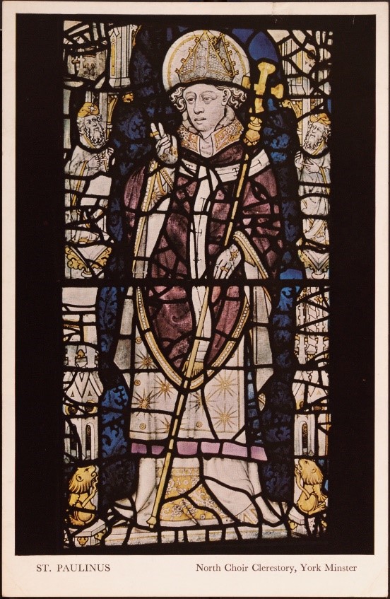 A postcard of a stained glass window showing a bishop